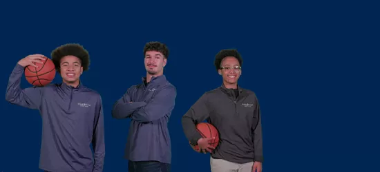 Three young adults standing in a row with a blue background.