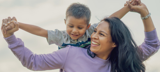 mom hold kid on her back walking
